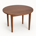 Watson Round Walnut Dining Table on a neutral background